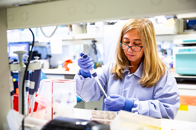 Female scientist working with medical equipment